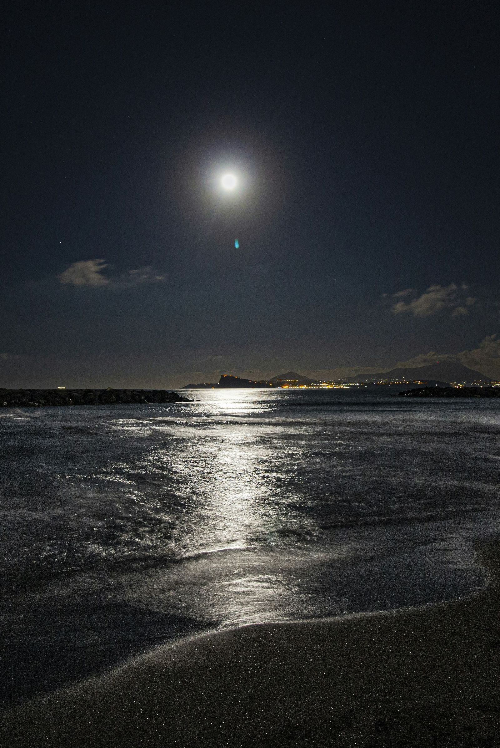 A serene view of a beach under moon light