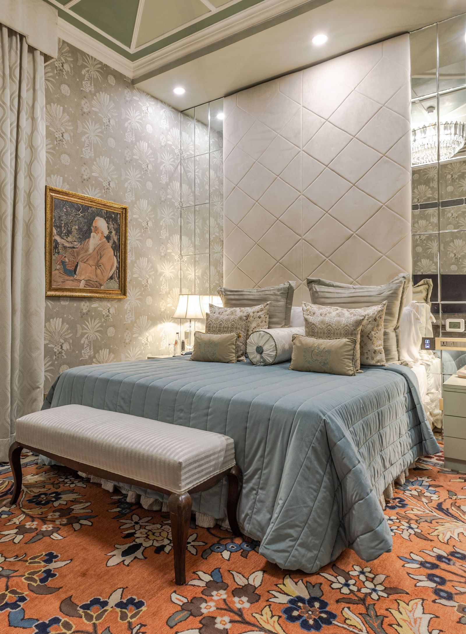 image of the spacious bedroom with plush bedding and long window curtains at our heritage luxury suite with whirlpool - The Claridges New Delhi