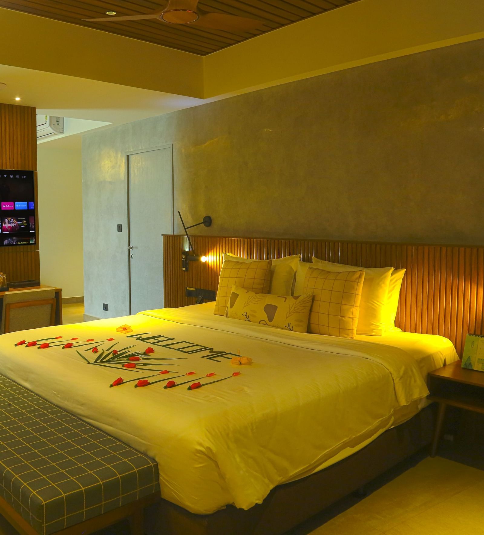An image of the pent house with a king size bed, couch, bed side table, flat screen TV, and separate living area - Great Trails Yercaud by GRT Hotels - Yercaud Family Rooms