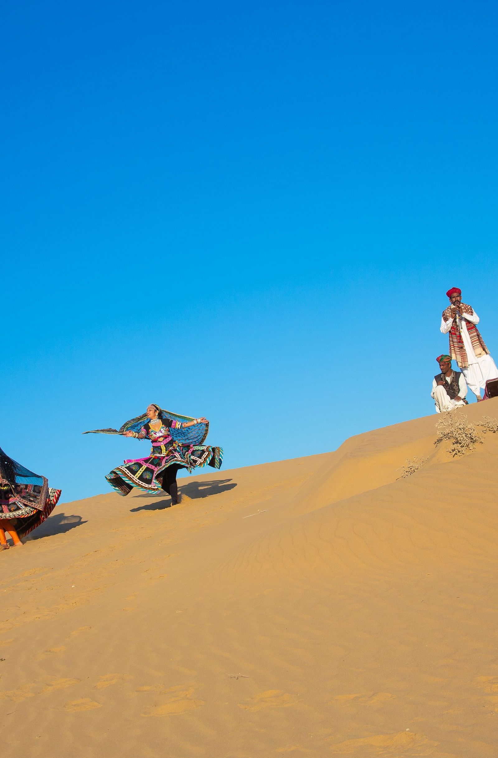 Artisans performing the local dance in the desert