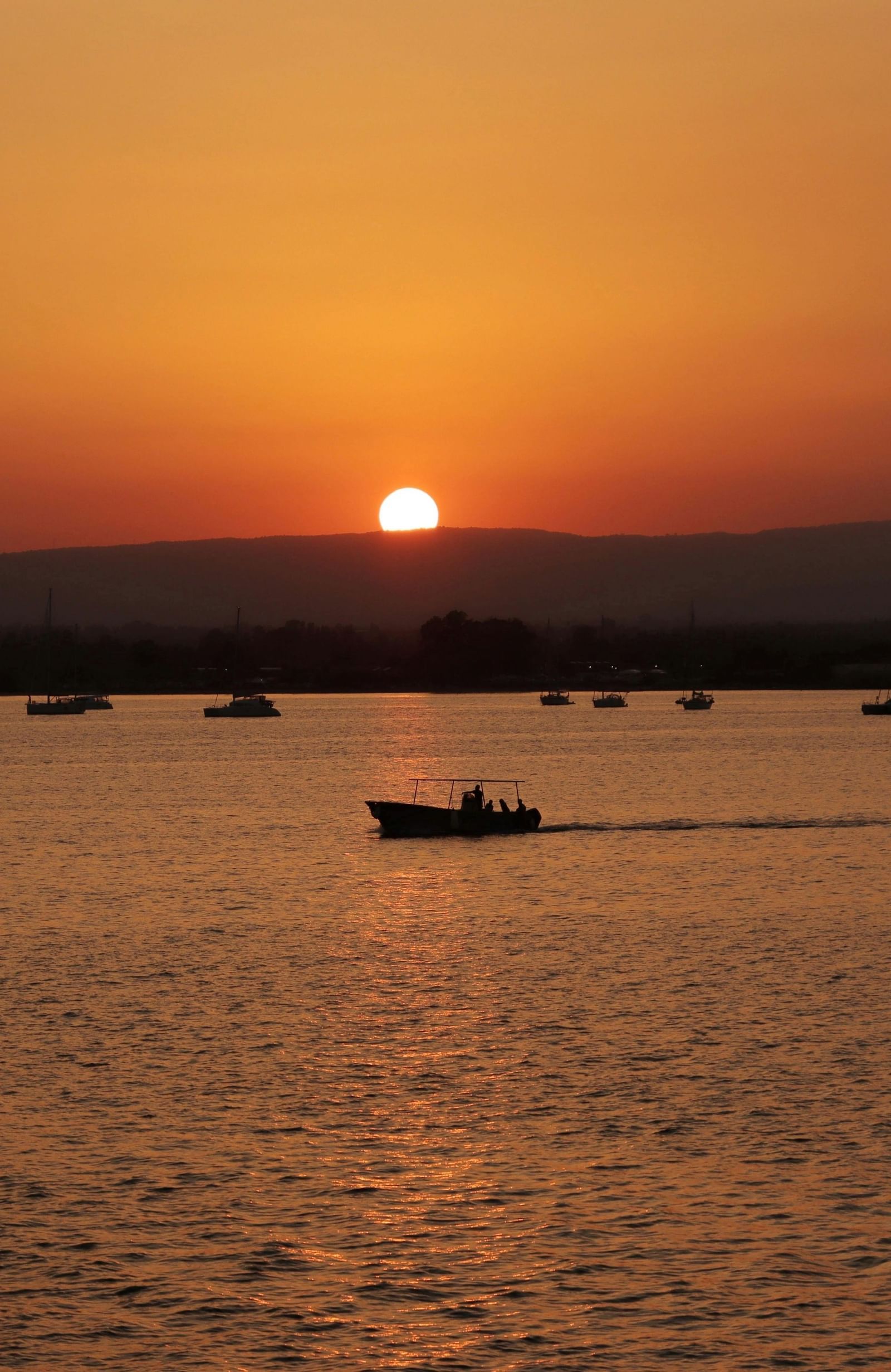 A boat on a lake at sunset