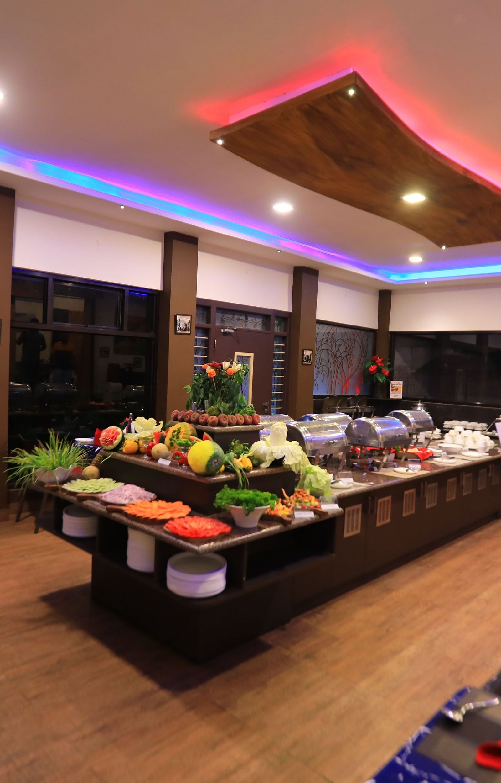 Image of a dining area with buffet table filled with food at Parampara Resort & Spa, Kushalnagar.