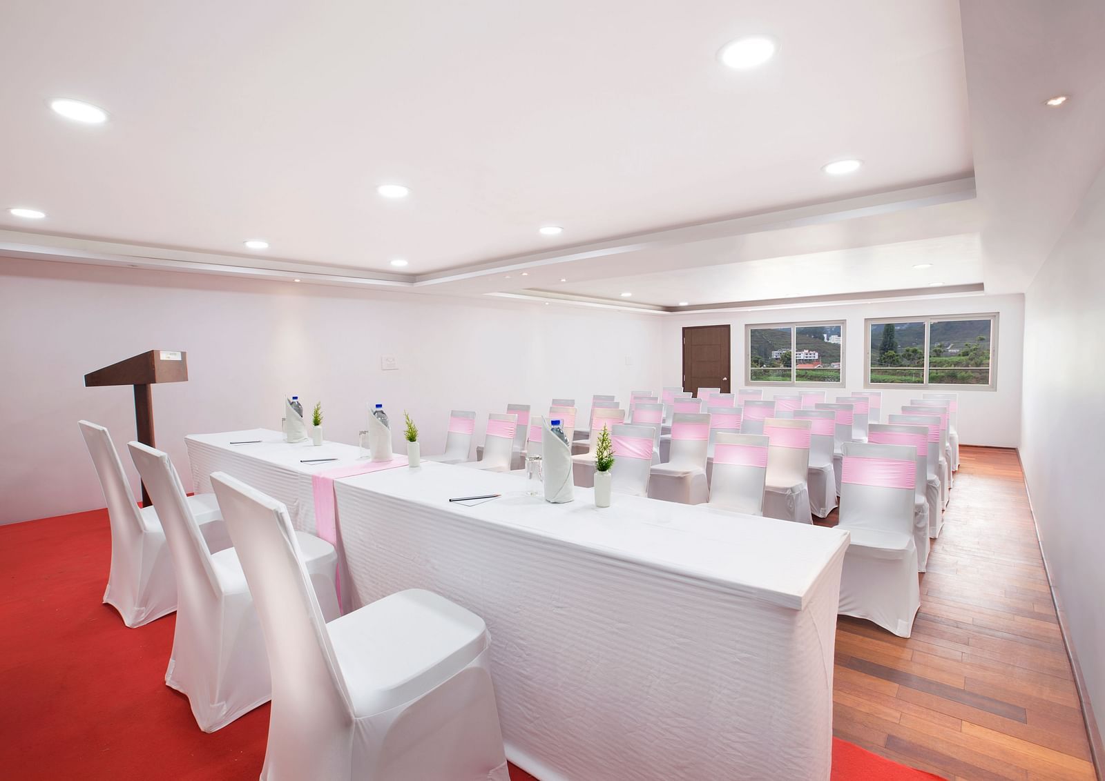 An image of a banquet space which is brightly lit with seating arrangement - GReaT Trails Kodaikanal By GRT Hotels