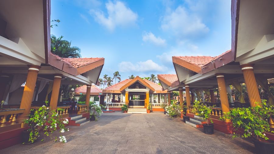 A wide view of the exterior of the cottages at Paradise Isle Beach Resort, Udupi during the day