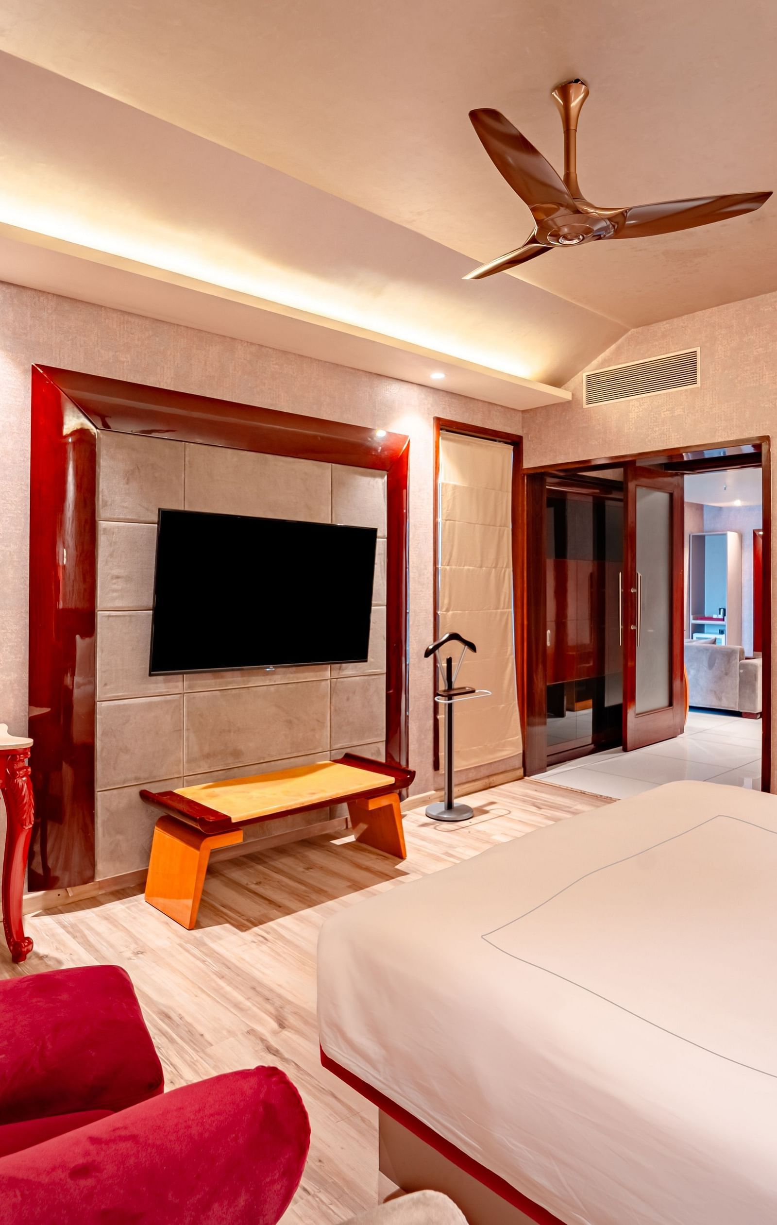Executive Suite features a spacious bed with a bedside table, warm lighting, and a pathway leading to the next room at Crescent Spa & Resort, Indore