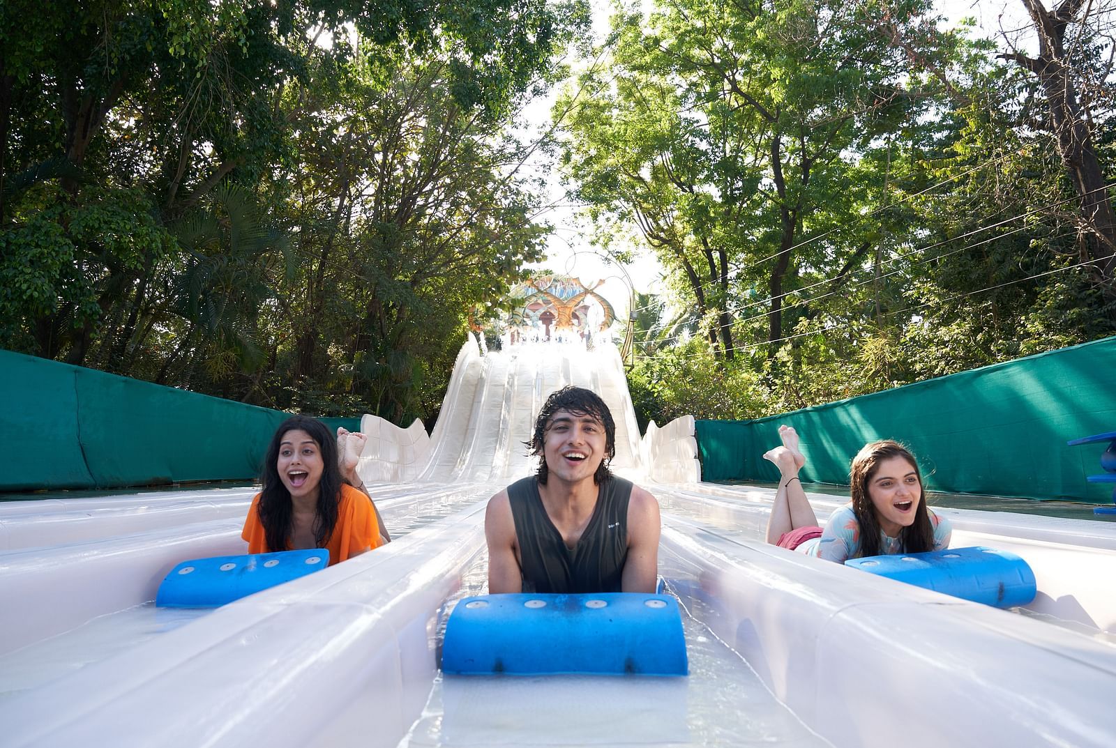 Three people enjoying What-A-Coaster at Water Kingdom while sliding down
