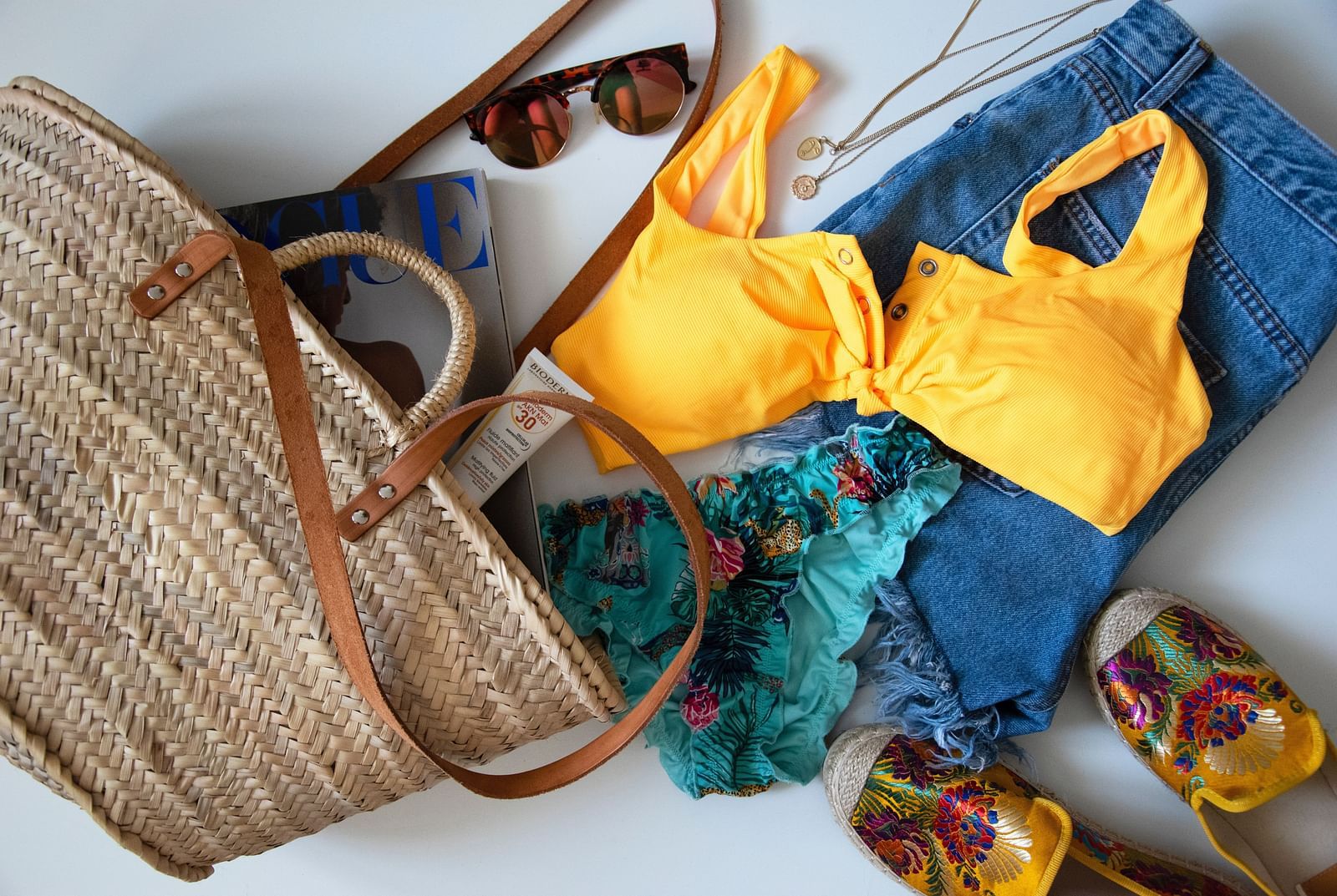 a bag with beach attire sunscreen and shades