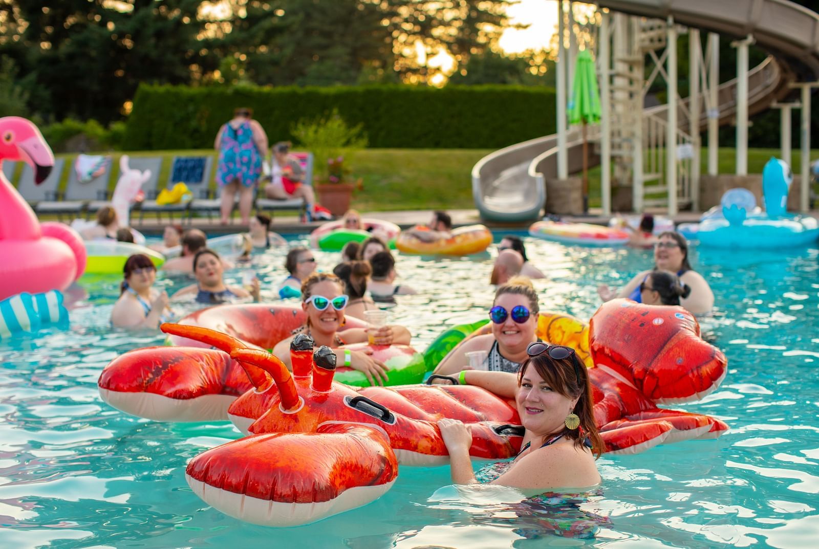 People swimming in the pool with inflated toys