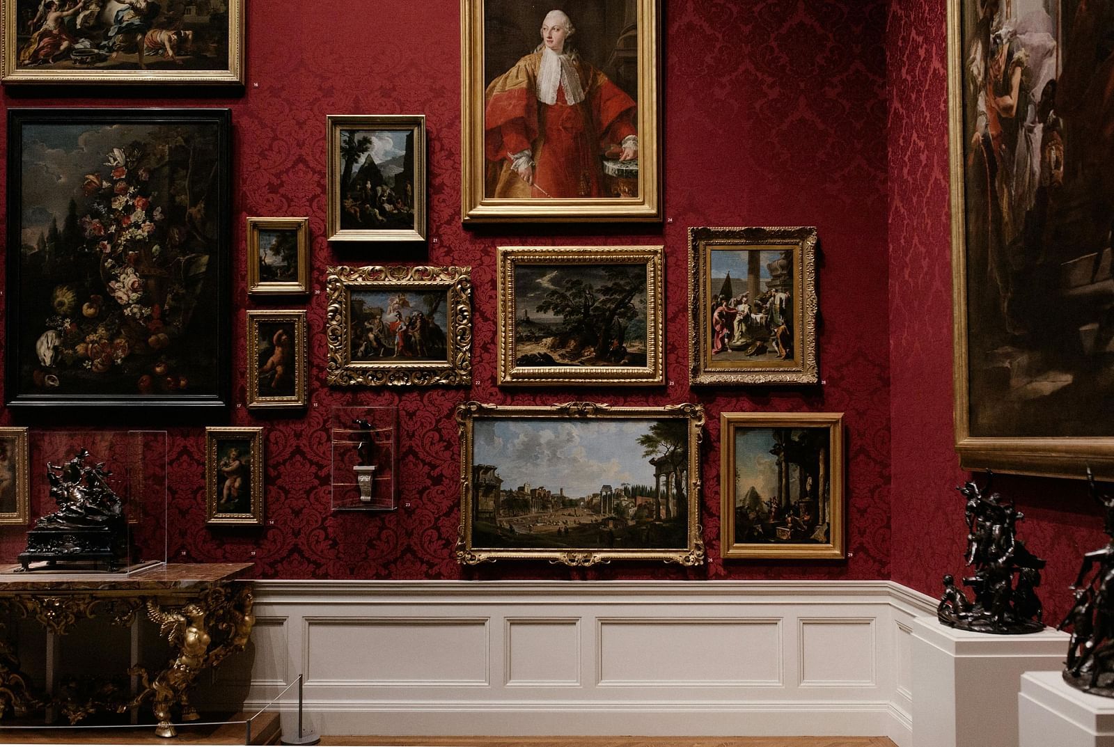 An interior view of the museum featuring paintings and photo frames displayed on the walls
