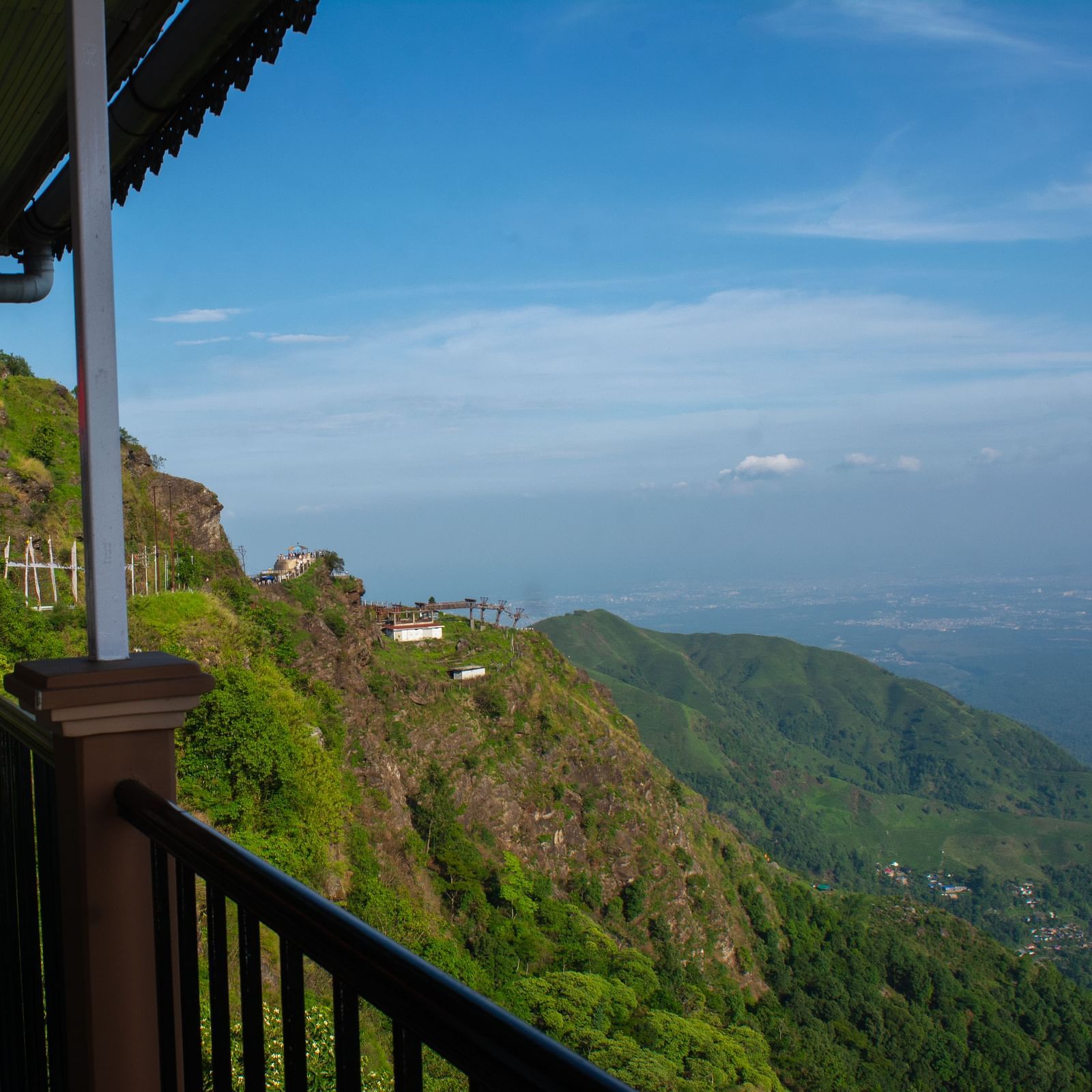 Valley view from a balcony showcasing mountains and clear sky