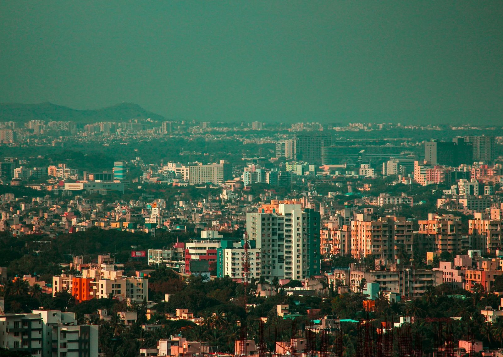 An aerial shot of the city of Pune with building seen till the distance.