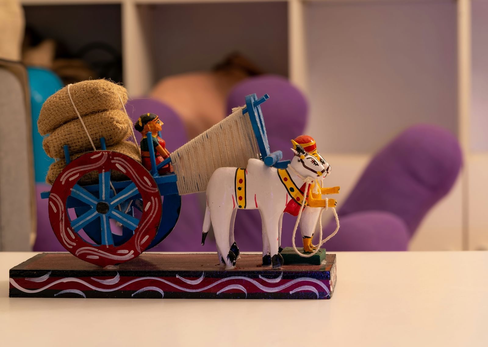 A toy symbolising about Pongal with a farmer taking her grains in a bullock cart.