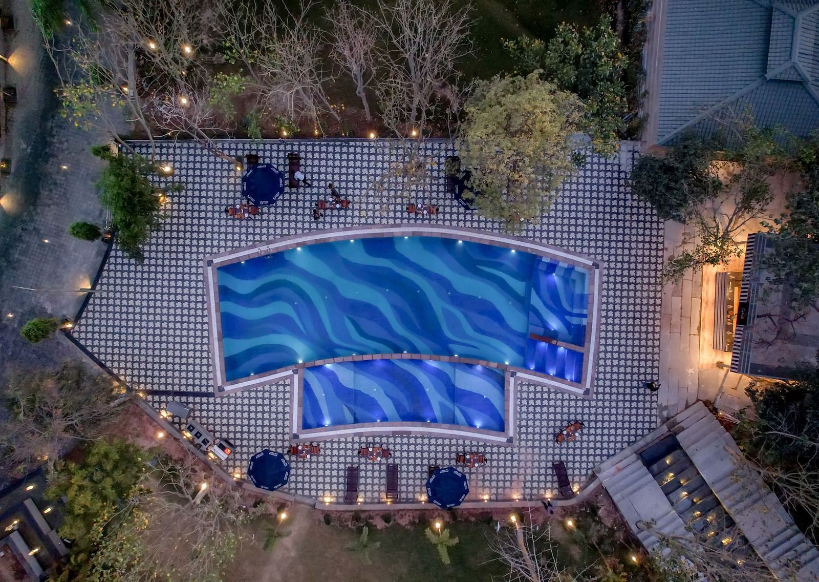 An aerial view of the swimming pool at Essentia Luxury Resort & Spa, Udaipur.