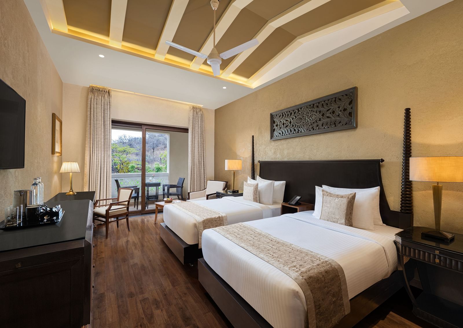 Premium room with a two single size beds placed in front of a TV at Essentia Luxury Resort & Spa, Udaipur.