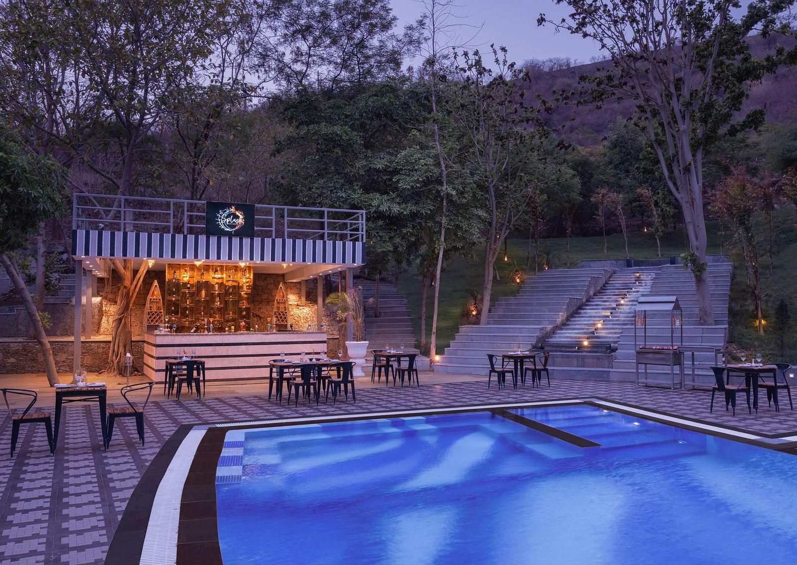 An overview of the seating inside Splash Bar Grill next to the swimming pool - Essentia Luxury Resort & Spa, Udaipur.