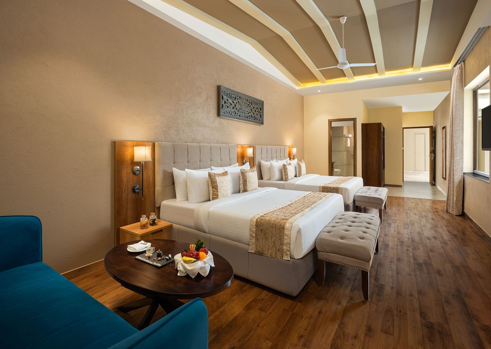 Studio Quad Room with double beds placed in front of TV at Essentia Luxury Resort & Spa, Udaipur.