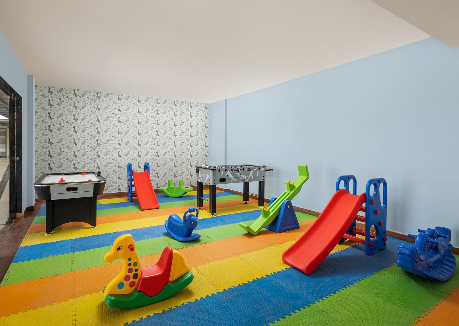A playroom with toys placed on colourful mats at Essentia Luxury Resort & Spa, Udaipur.