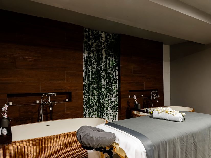 A treatment room in our spa in Montego Bay with a bed - S Hotel Montego Bay, Jamaica