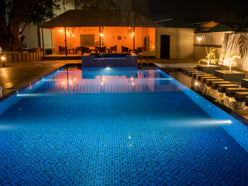 overview of the swimming pool with the restaurant in the background - Hotel Wedlock Greens, Dhanbad