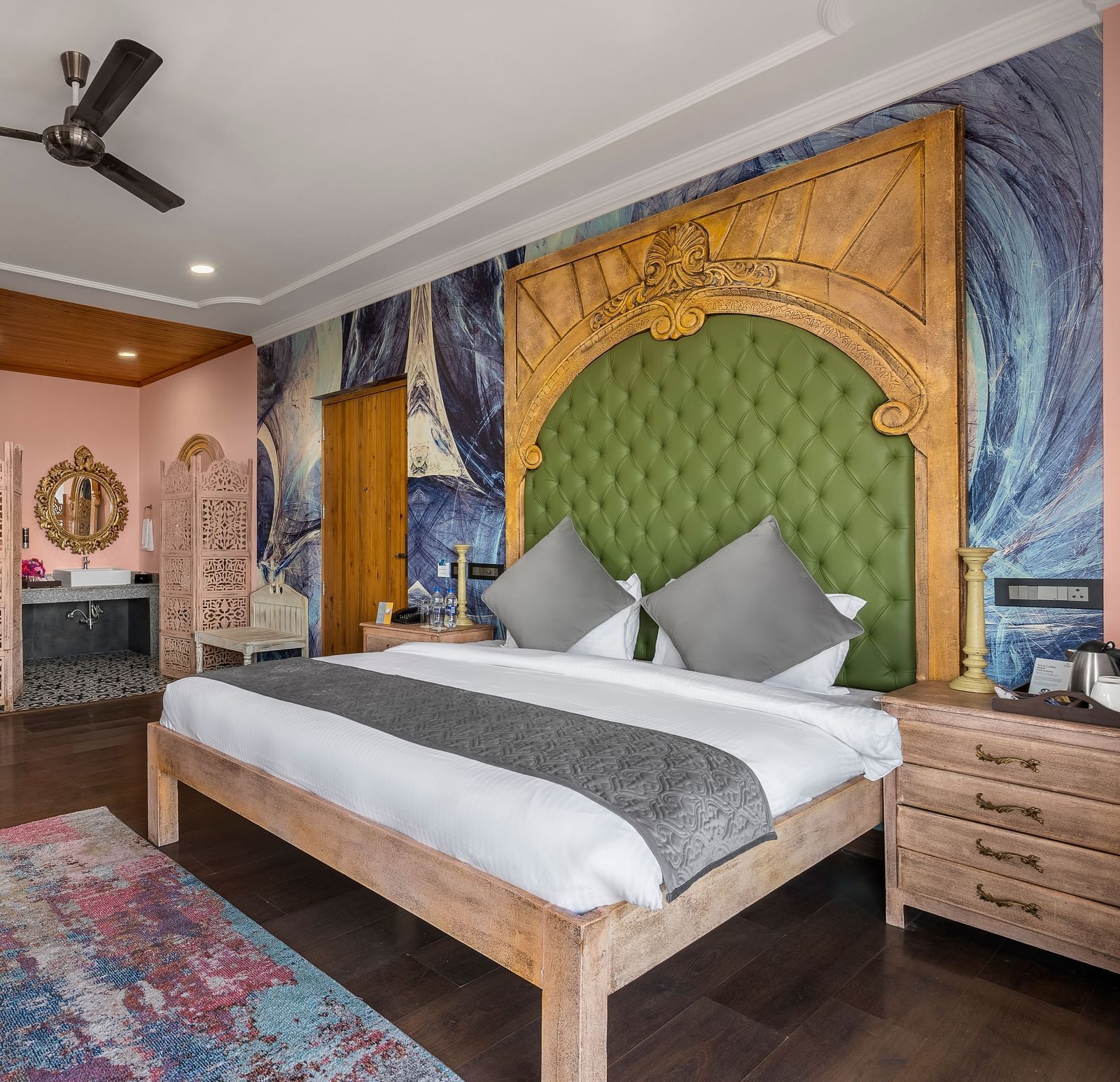 a bedroom with a large double bed and two sofas with a table - Atman, Dharamshala