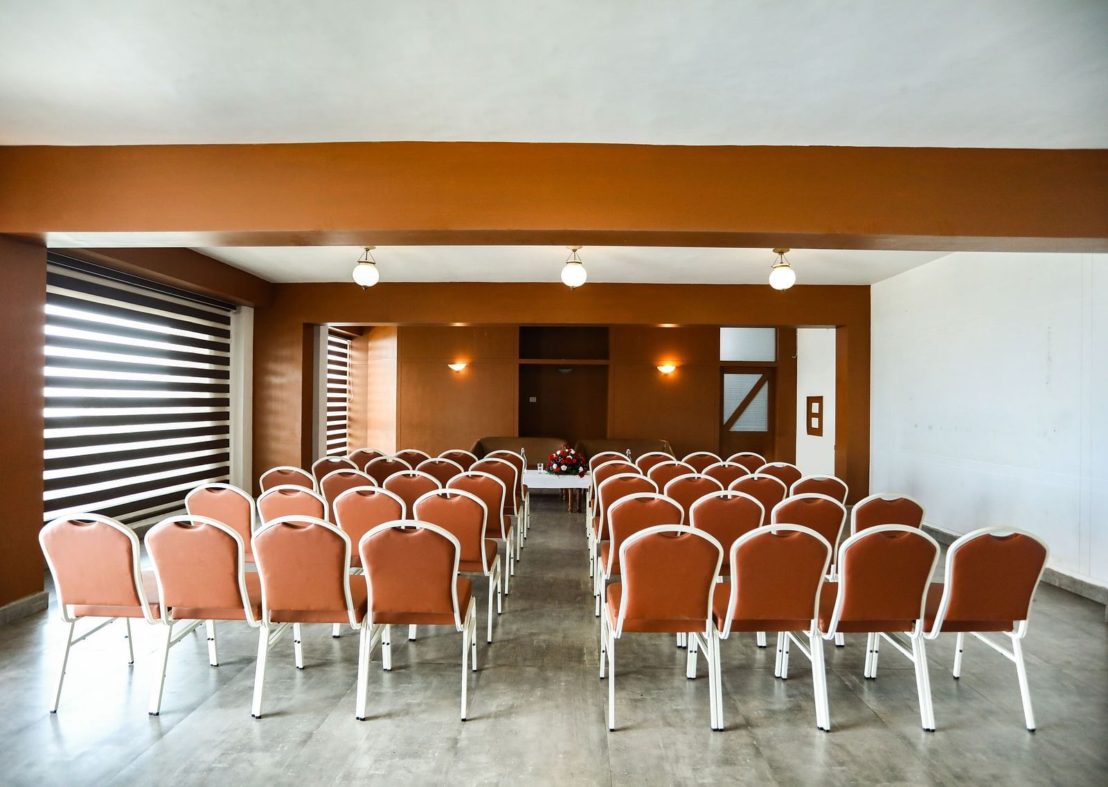 brown and white chairs placed in the banquet hall of La Montana By TGI, Ooty