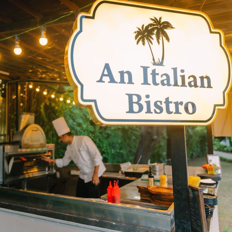 An Italian Bistro Restaurant image with a person working in the open kitchen