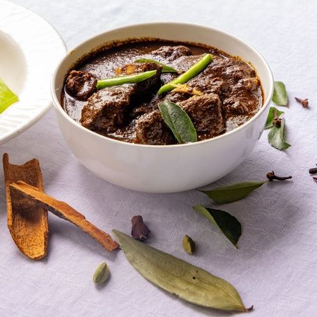 Coorg Pandi Curry with Kadambuttu rice balls.