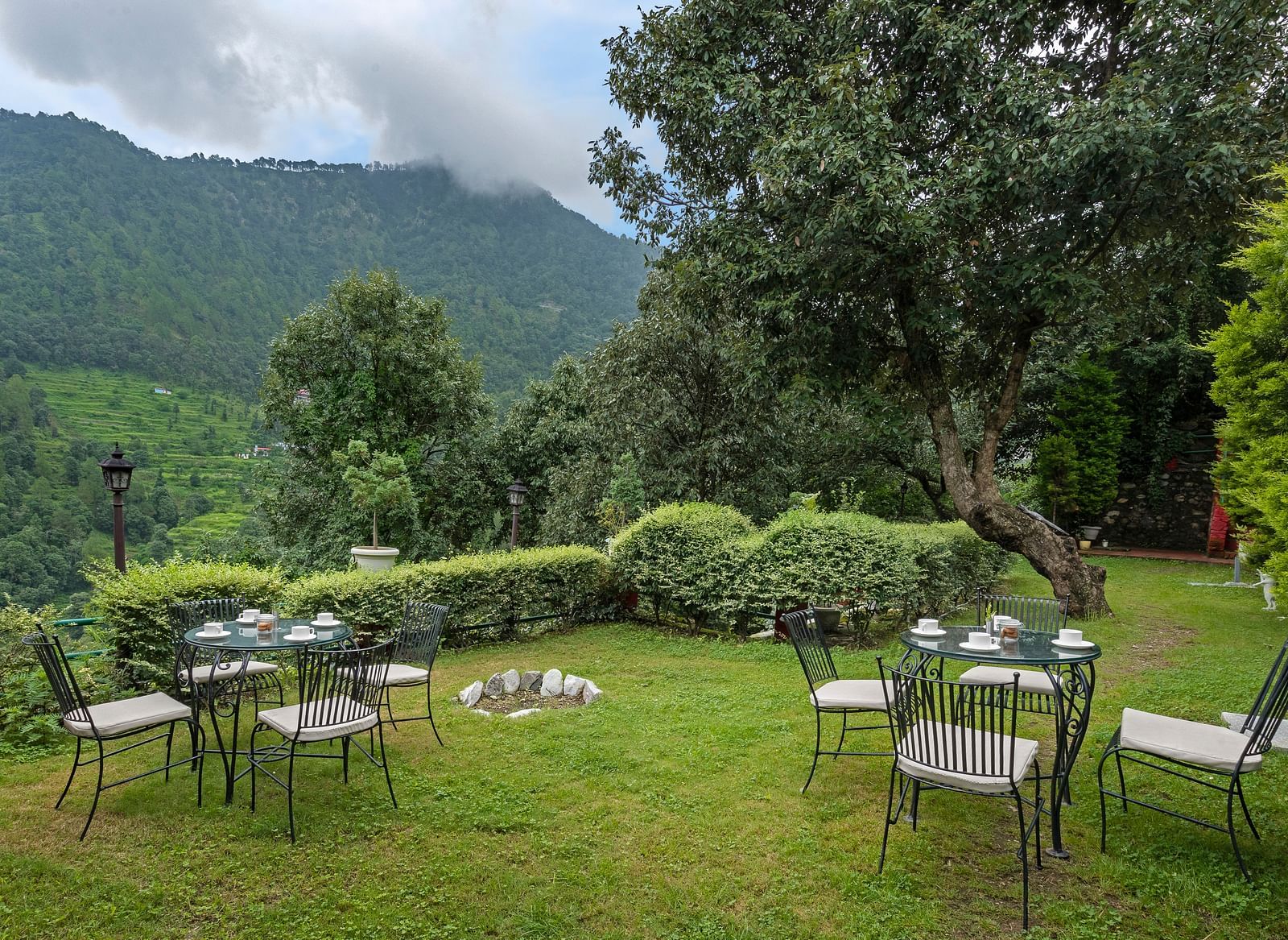 Outdoor lawn seating arranged in a circle with mountain views, at BluSalzz Collection - Suvaasa Resort, Ramgarh.