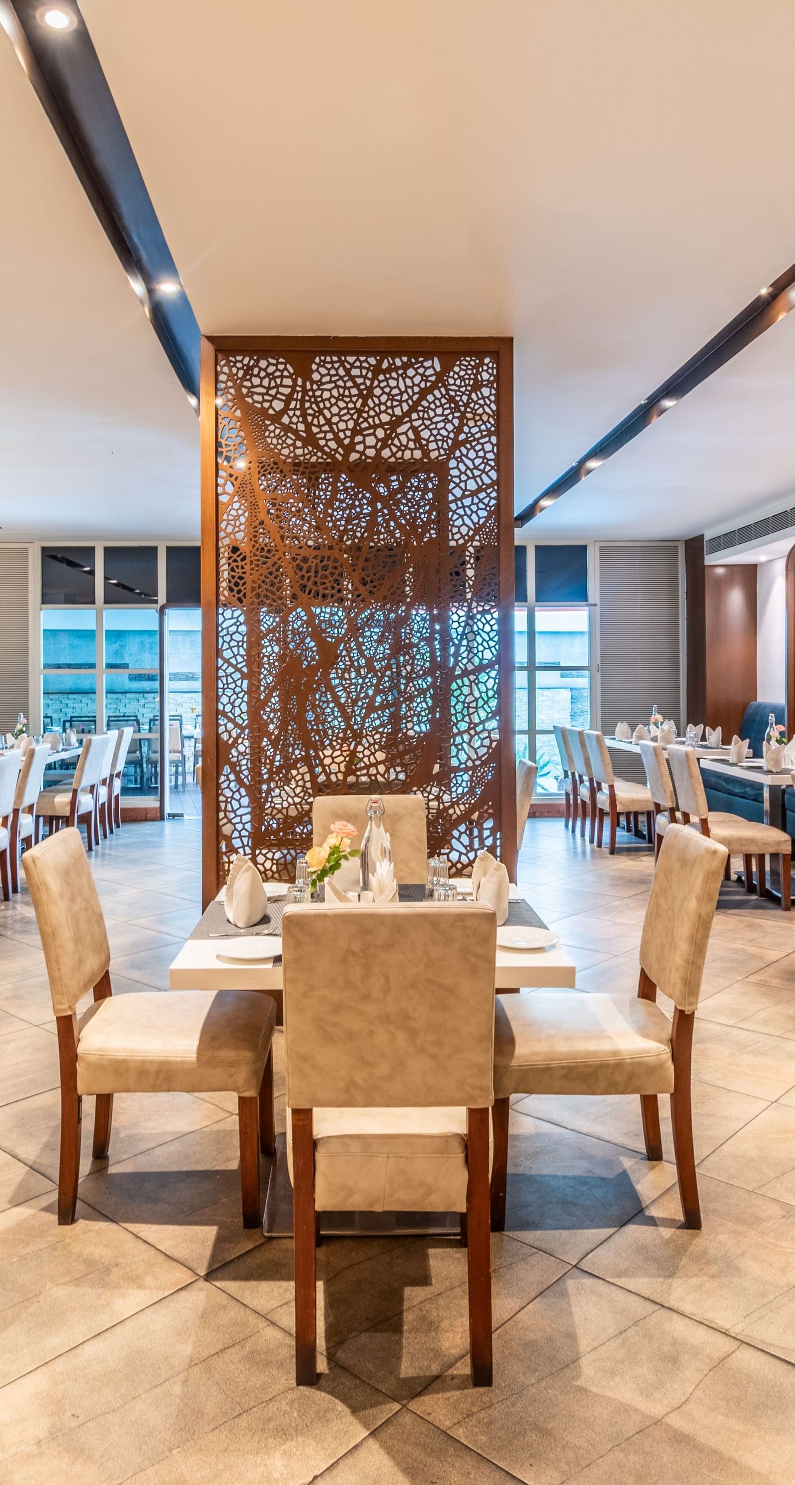 Stylish hotel restaurant with wooden interiors and well-spaced dining tables