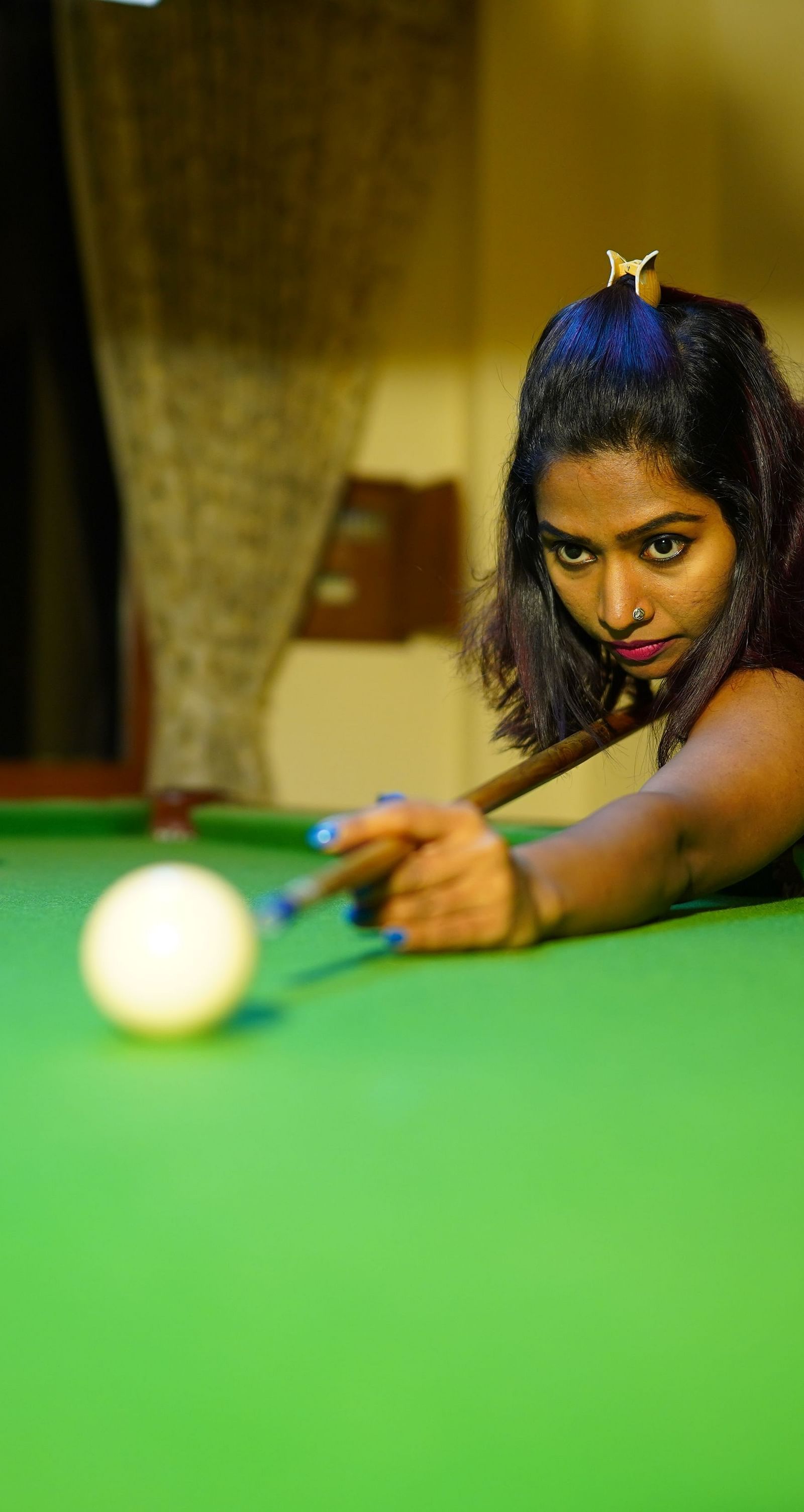 a woman playing pool at La Montana By TGI, Ooty