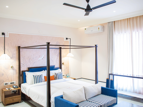 View of a cosy poster bed at The Sierra featuring a sofa