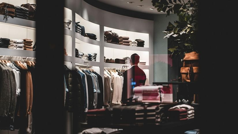 modern men's clothing store with a variety of shirt, jackets and sweaters on display