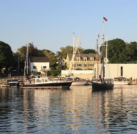 Picturesque harbour view with moored boats and waterfront buildings near Hartstone Inn