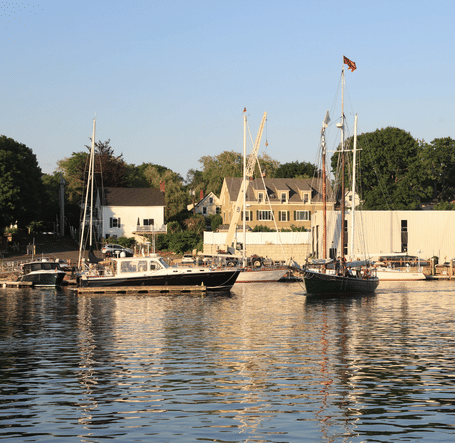 Picturesque harbour view with moored boats and waterfront buildings near Hartstone Inn