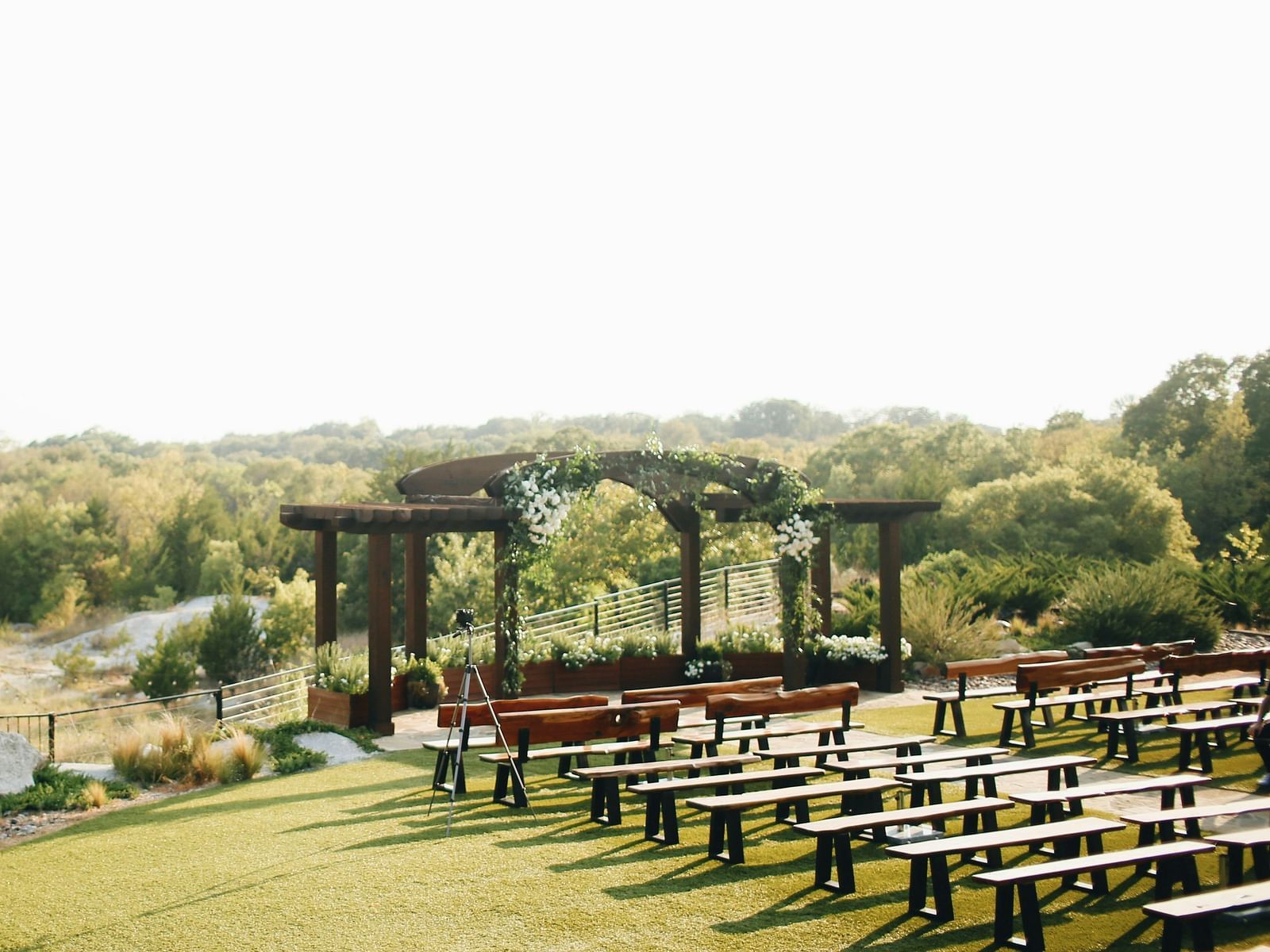 An aerial long shot of the wedding lawn, beautifully blanketed in lush greenery