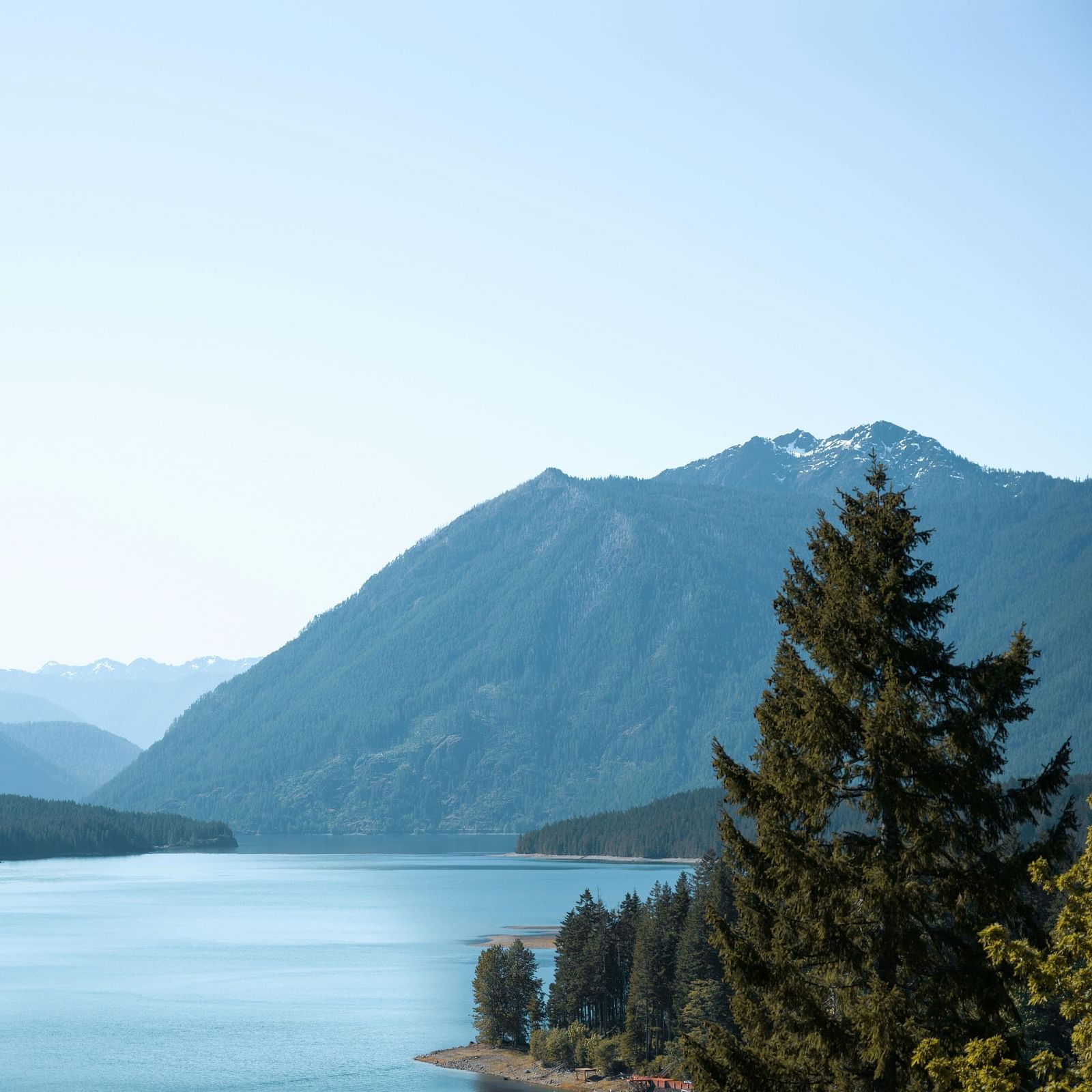 Scenic view of the lake surrounded by hills.