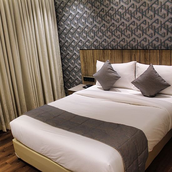 Deluxe King room with comfortable bed at Maxxvalue Hotel MIDC,  Mumbai