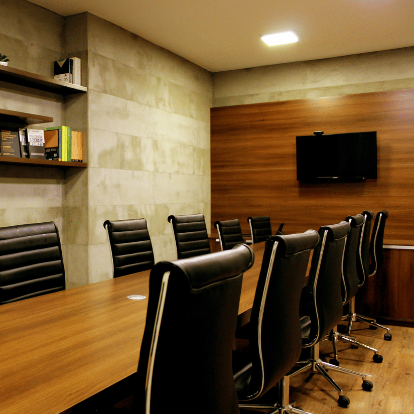 Interior of a conference room featuring a table surrounded by several chairs.