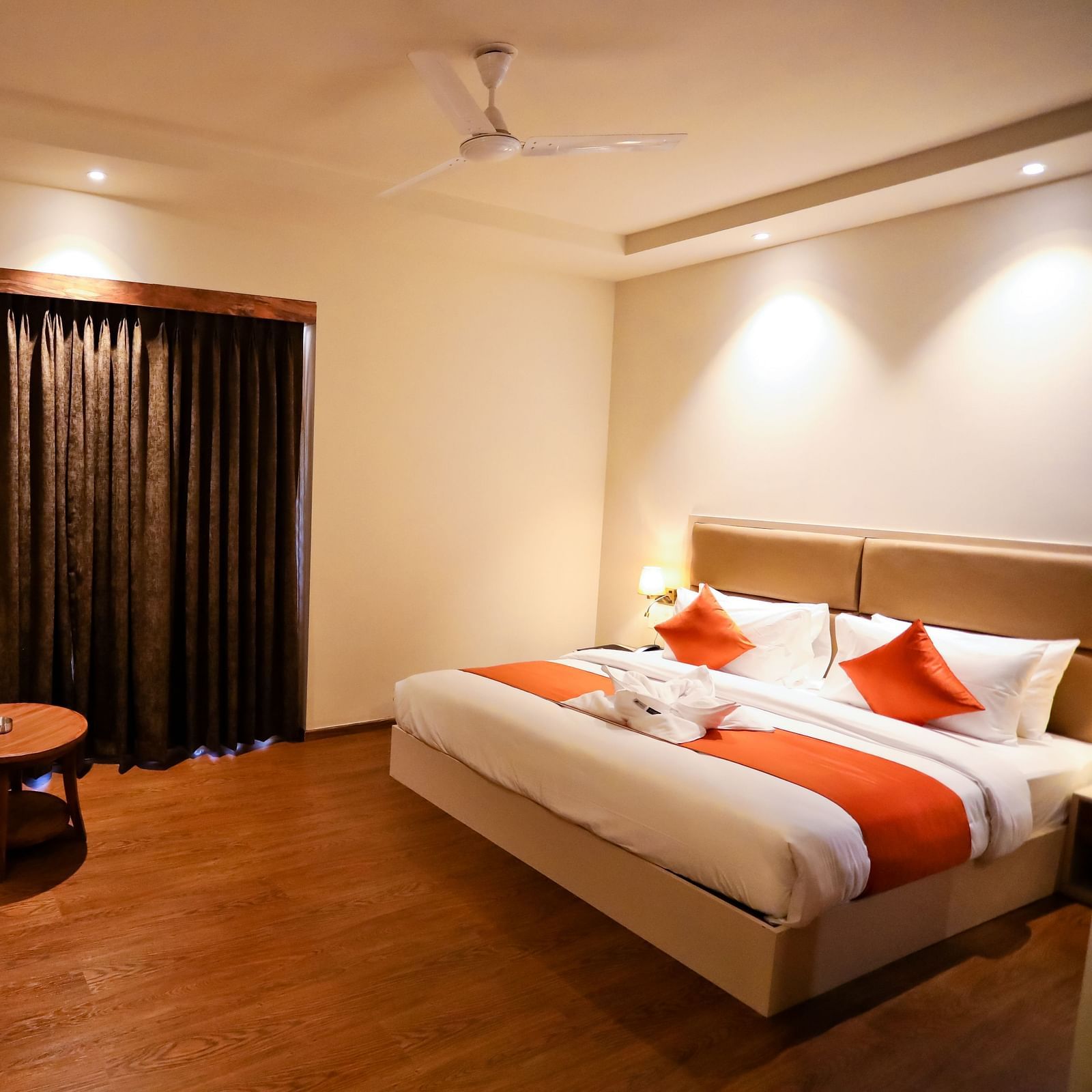Image of a room with a bed and a television in front and a seating area on the side at Calux Grand Baga.