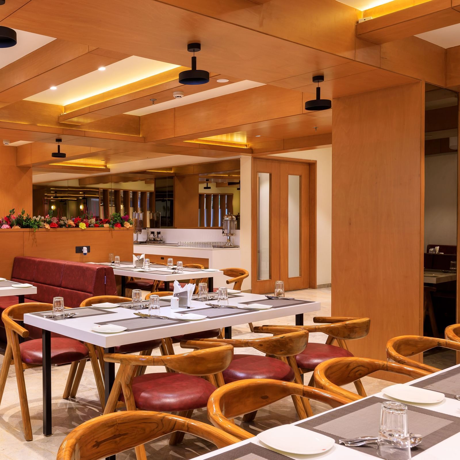A restaurant seating area with chairs, tables set for diners