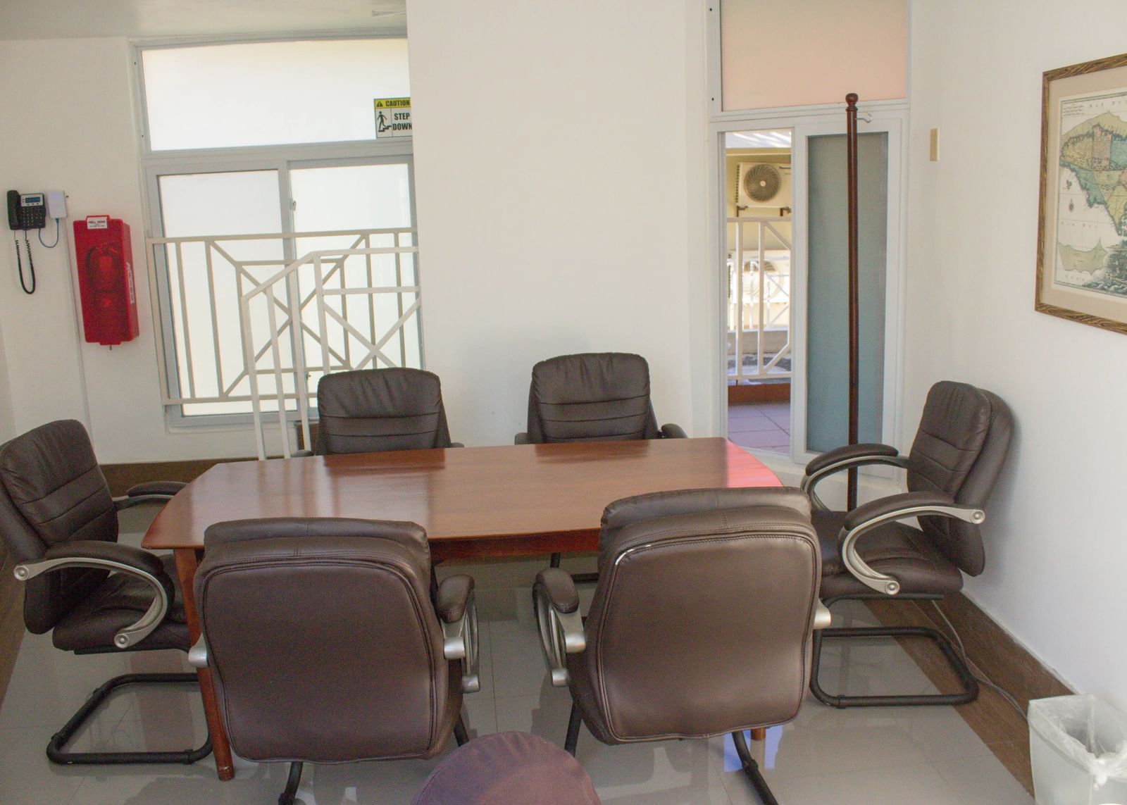 A conference room with a large table and chairs, set up for a meeting or discussion | Breakaway Room | Altamont Court, Jamaica