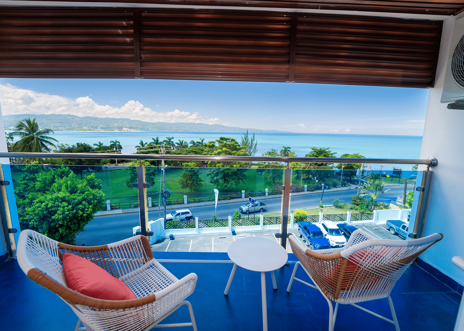 An image of a balcony in our Montego Bay hotel room that opens to the view of the coast of Montego Bay - Hotel 39, Jamaica (Montego Bay).