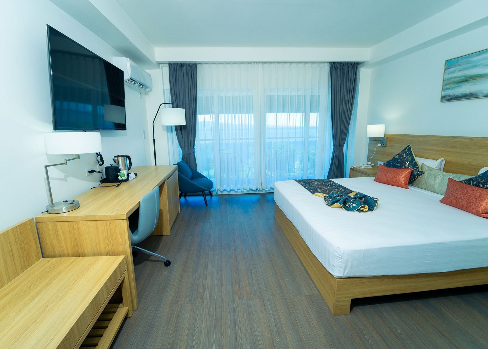 An image of a hotel room in Montego Bay with a king size bed and a wall mounted television - Hotel 39, Jamaica (Montego Bay)