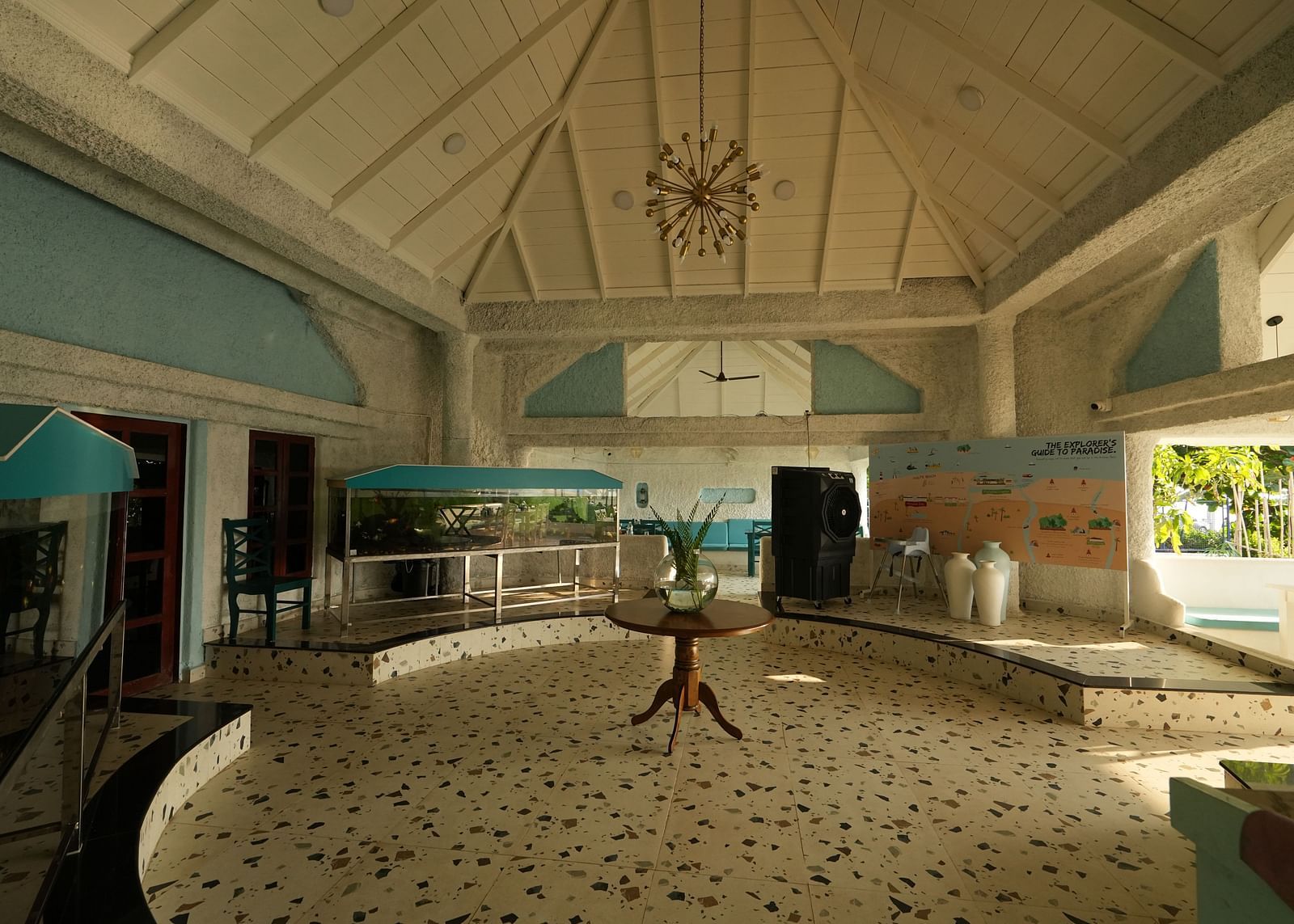 Lobby area of a restaurant at Paradise Isle Beach Resort, Udupi with pastel blue and white theme