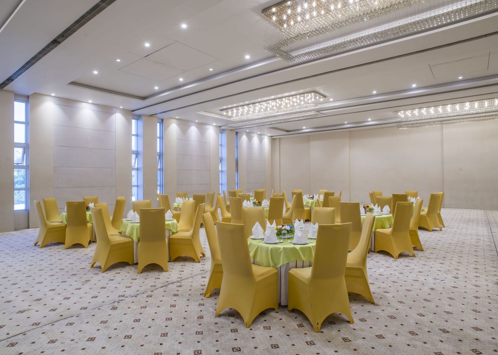 A large meeting room with yellow chairs at The Citi Residence Hotel, Asansol.