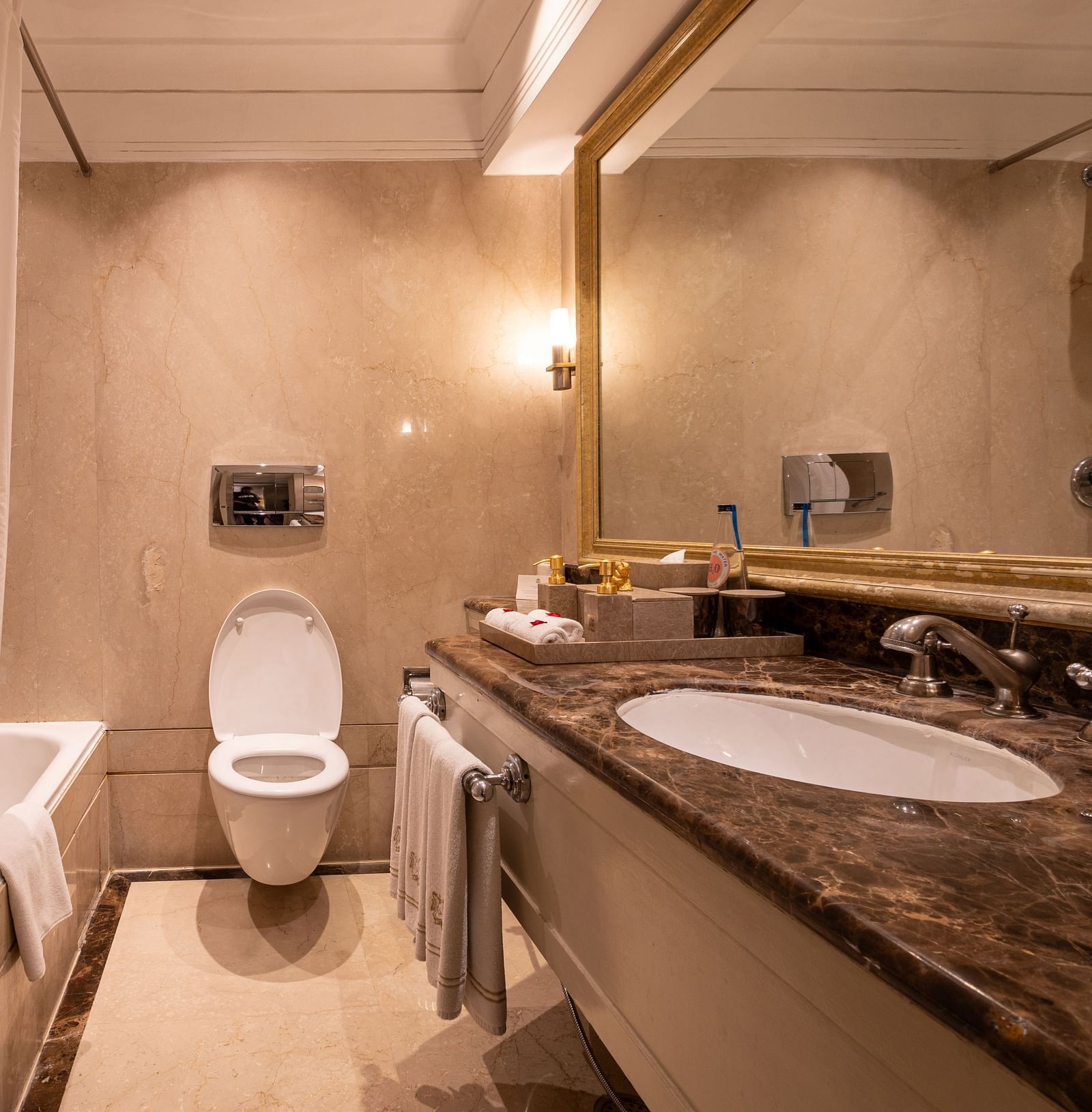 Washroom of the Superior Twin Bed Room at The Claridges New Delhi, featuring a sleek sink and a wall-mounted mirror