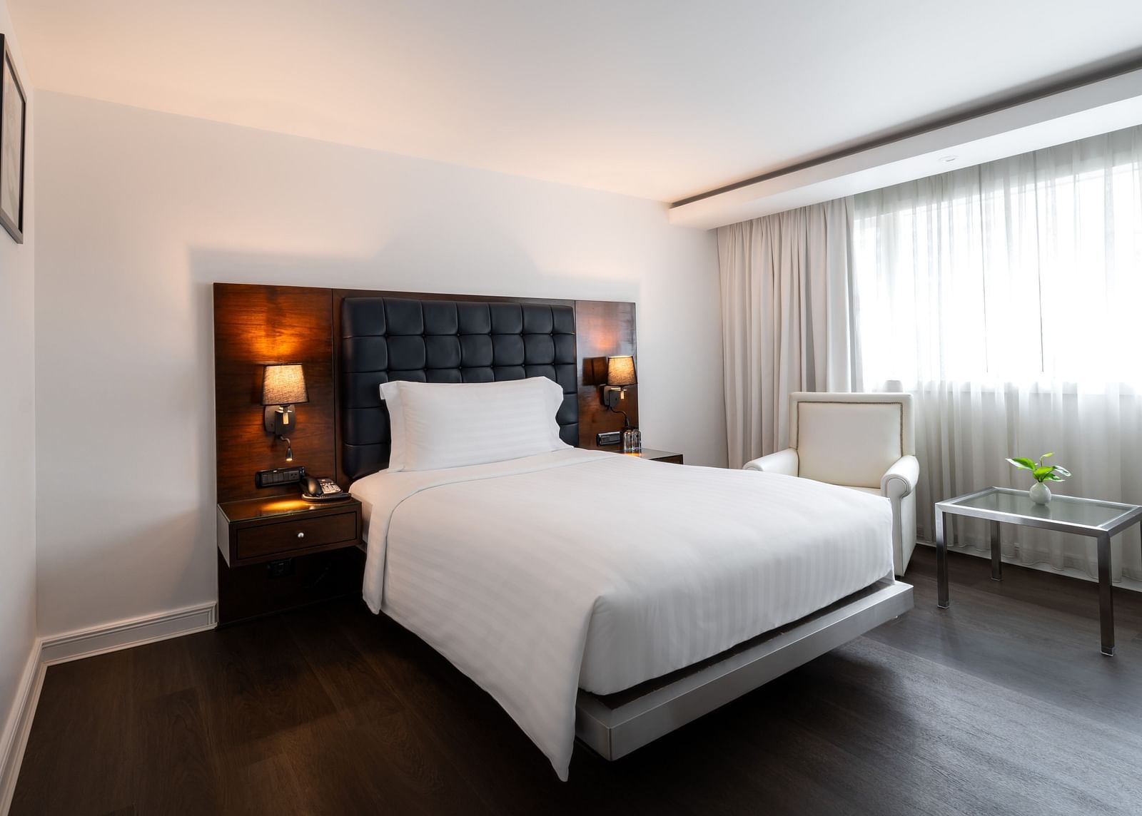 An overview of a single bed with side tables and lamps - Night Hotel Bangkok.