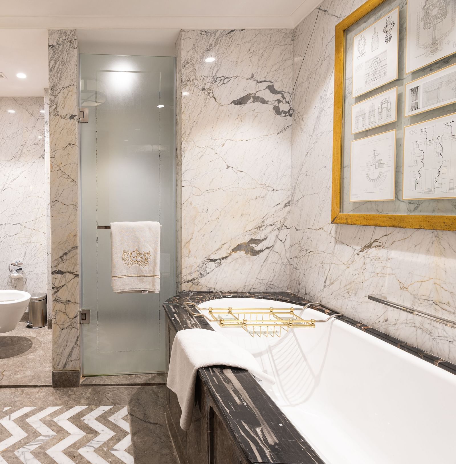 Luxury King Bed Room washroom at The Claridges New Delhi, featuring a bathtub and a glass-enclosed bath area