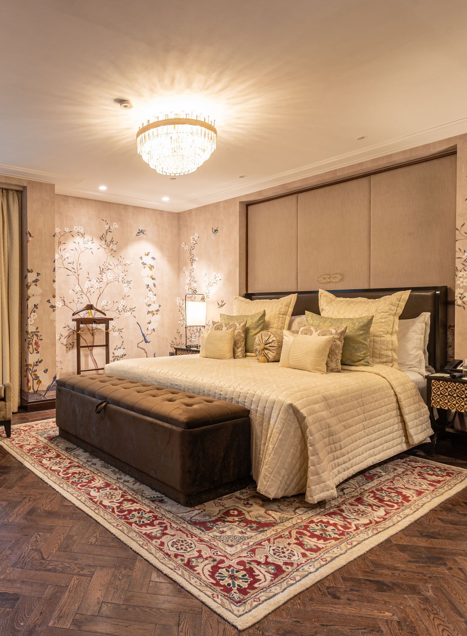 image of the bedroom of the cabana room featuring a modern interior with grey themed colour tone - Image of the Cabana Room featuring two single-seater couches and a wall-mounted television - The Claridges New Delhi