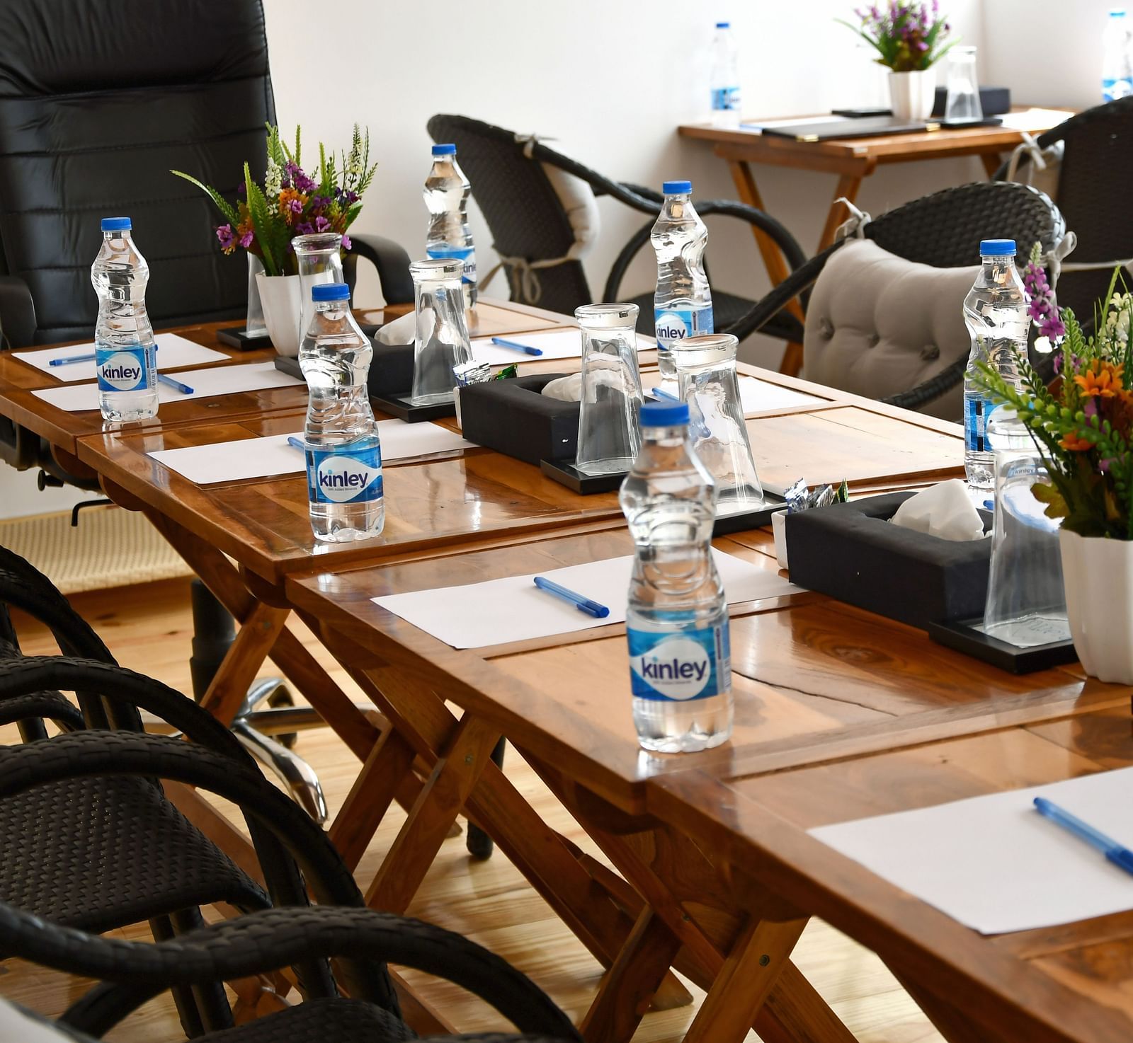 close up image of the table in the conference hall with white sheets kept on the table at the tattva, joshimath